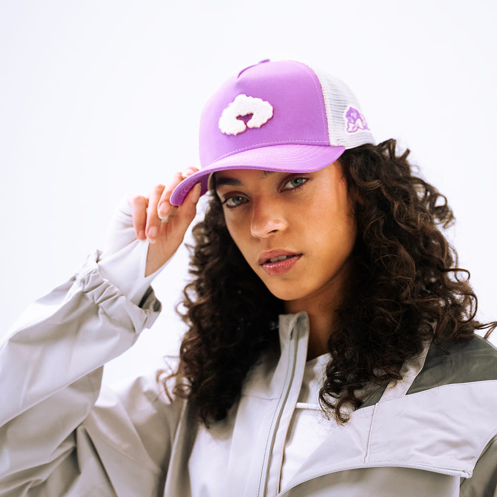 Coziya purple trucker hat worn by woman outdoor lifestyle