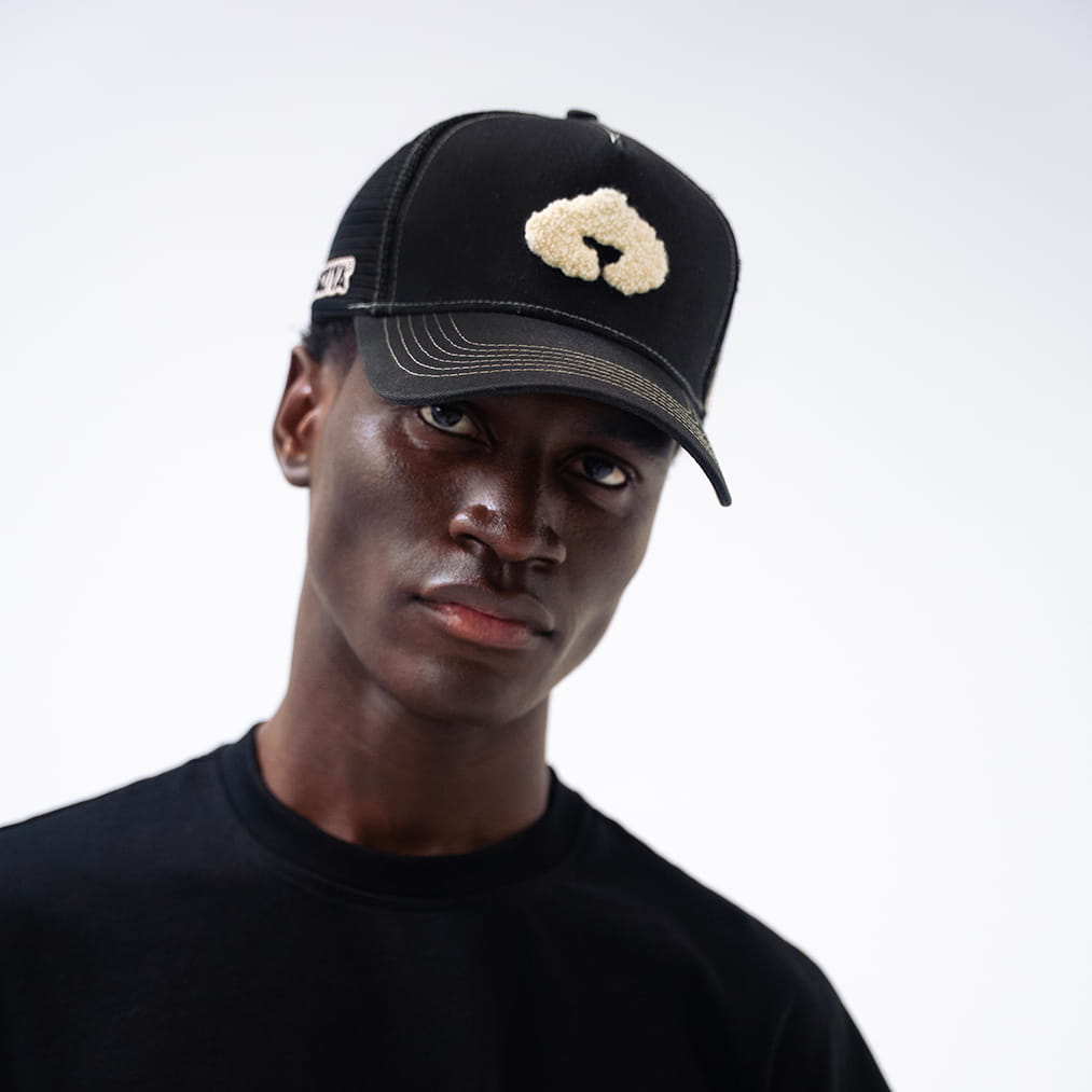 Coziya black trucker hat worn by man outdoor lifestyle