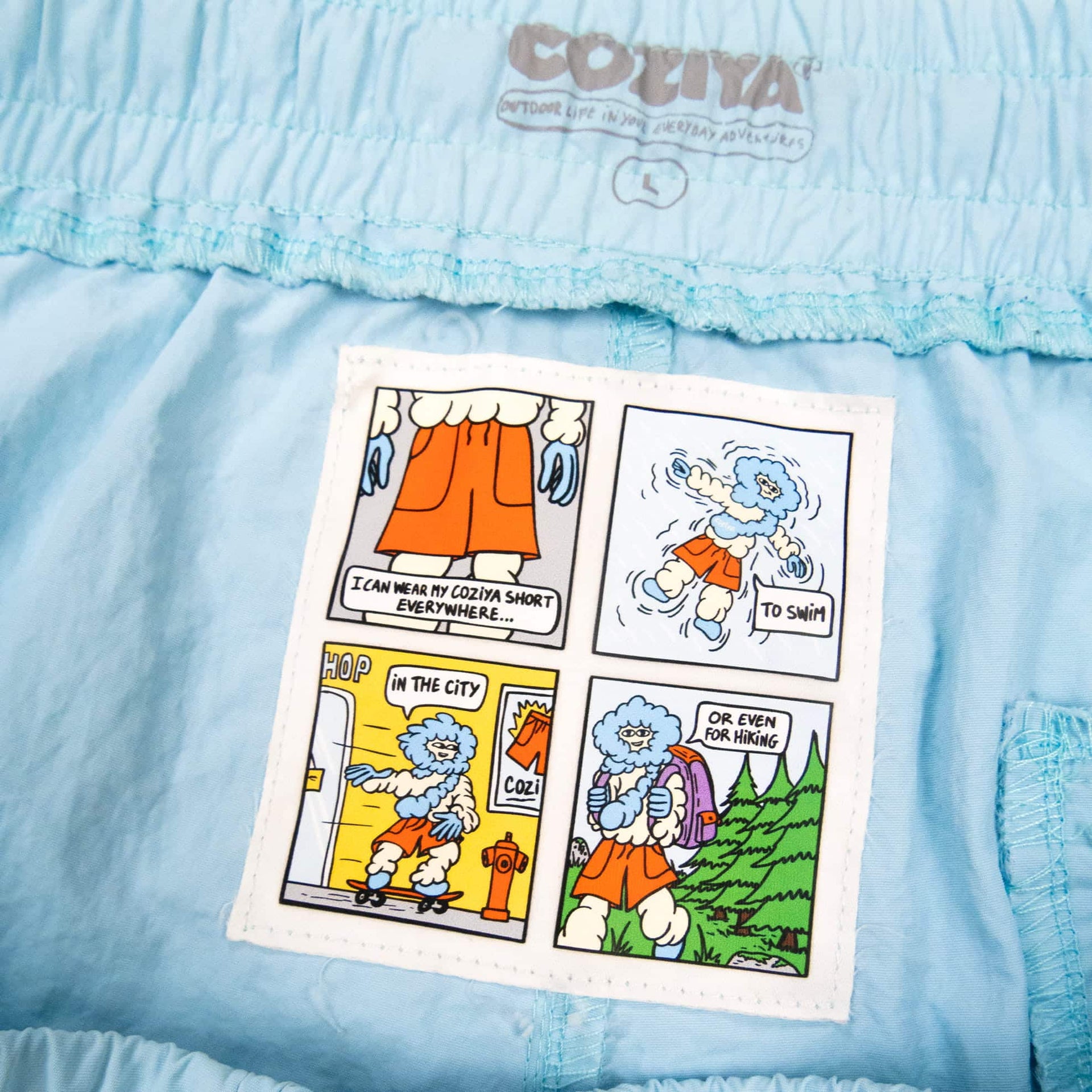 Coziya blue swim trunks interior label comic-strip woven detail