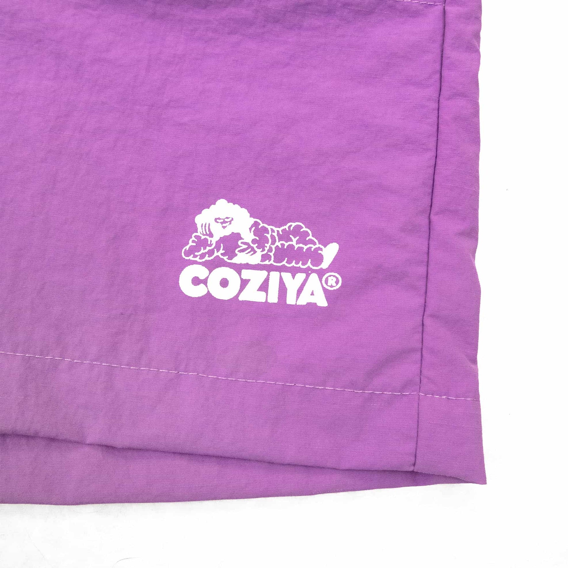 Coziya purple swim trunks logo detail front view