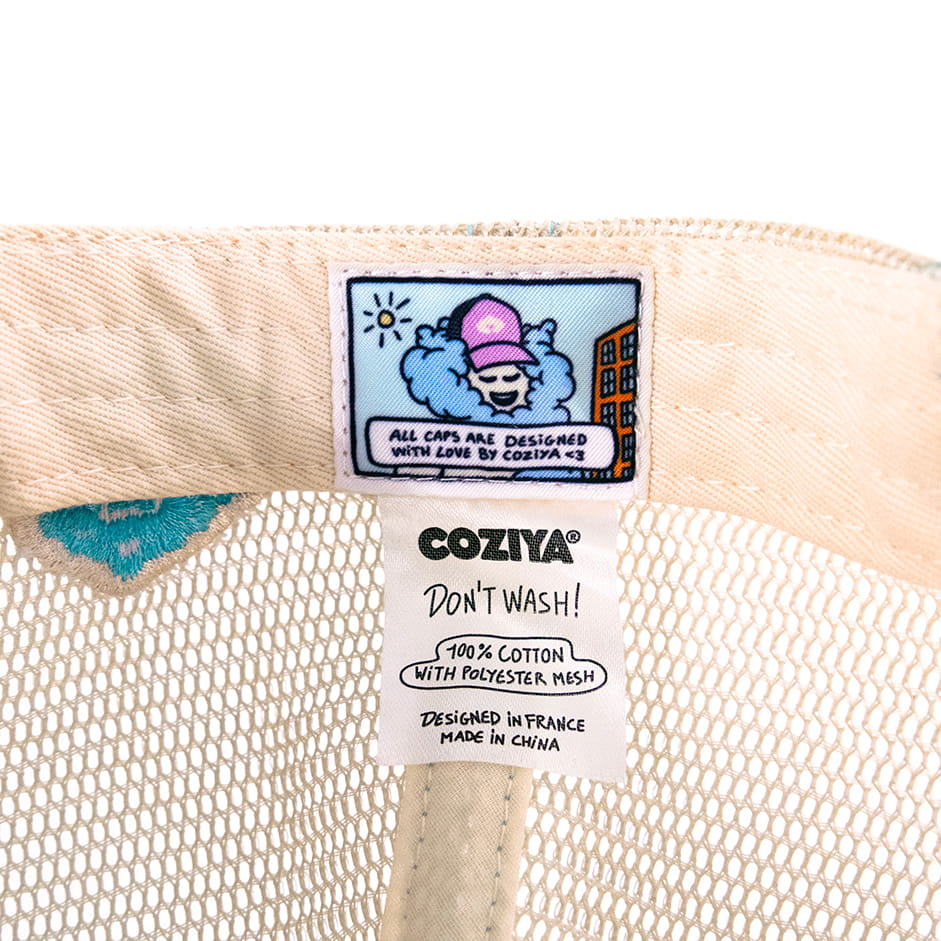 Coziya trucker hat comic-strip interior label close-up detail