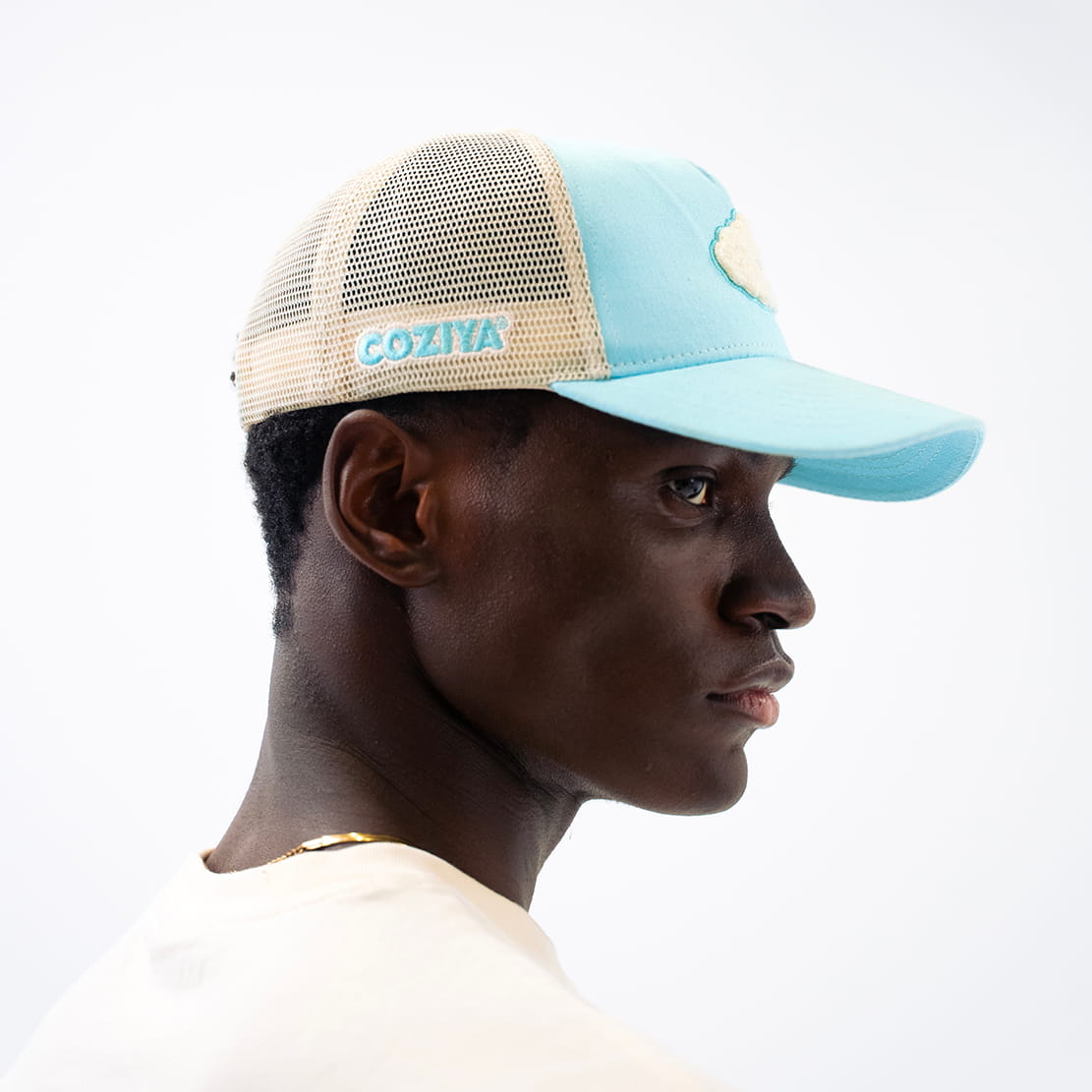 Coziya blue trucker hat worn outdoors side profile view