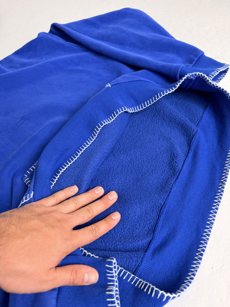 Hand pressing into the brushed fleece inside the hoodie