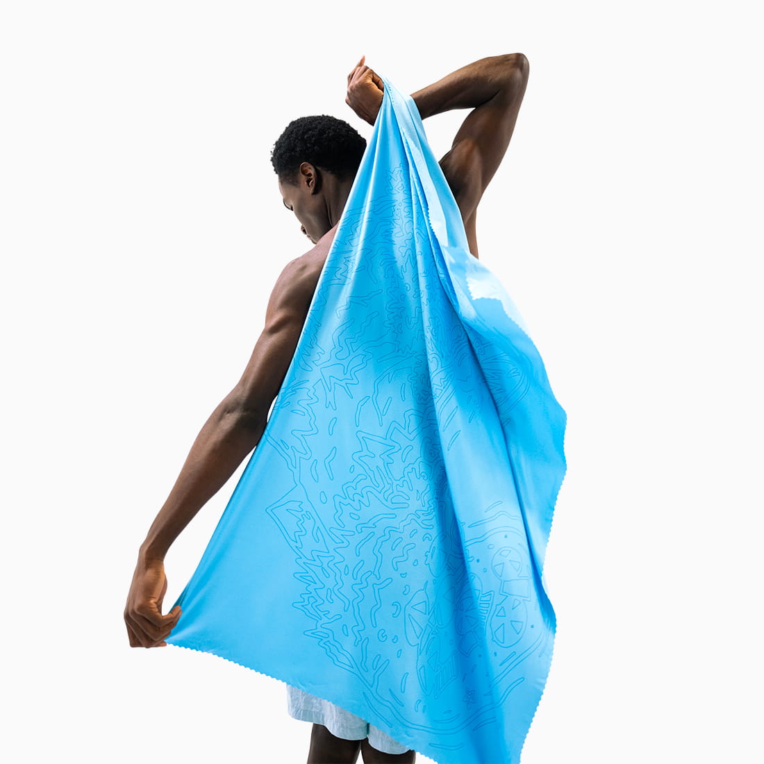 Coziya Air Towel blue microfiber beach towel used full length by man at beach