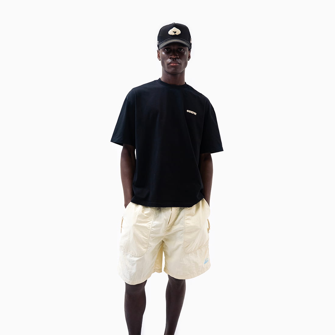 Coziya beige swim trunks worn by man outdoor beach lifestyle